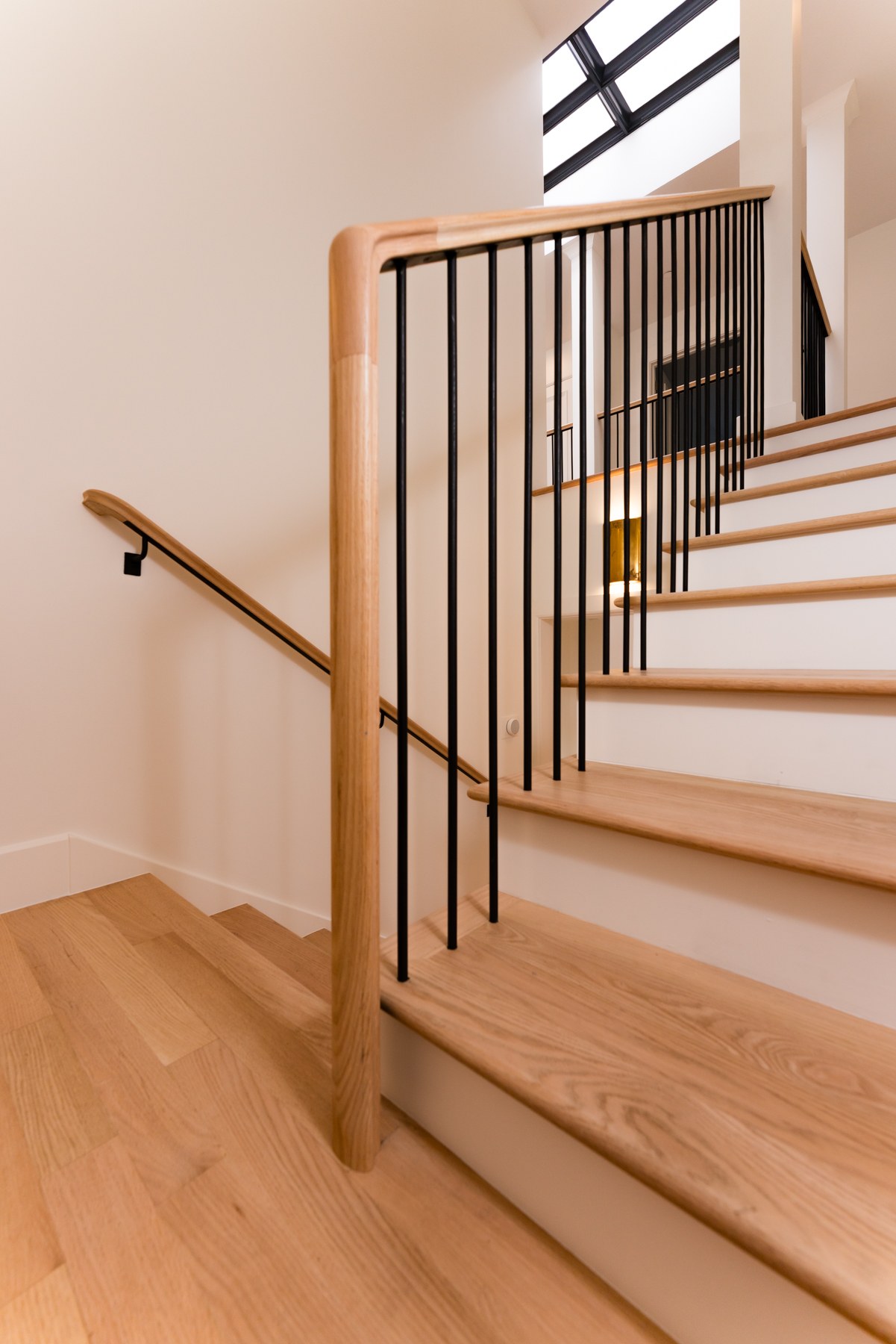Custom oak staircase with iron railings — Kentfield remodel craftsmanship